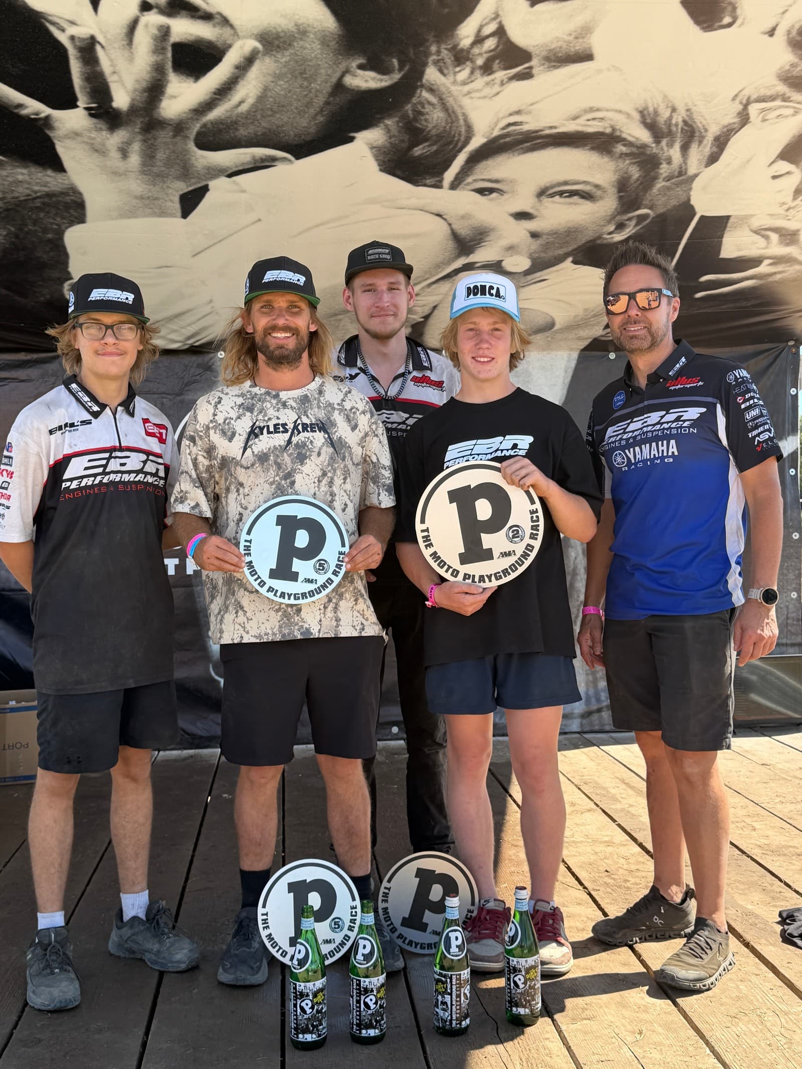 Reid Oehring celebrating at Ponca with coach Kyle Swanson and the EBR Performance crew; owner Josh Rogers stands at the far right.